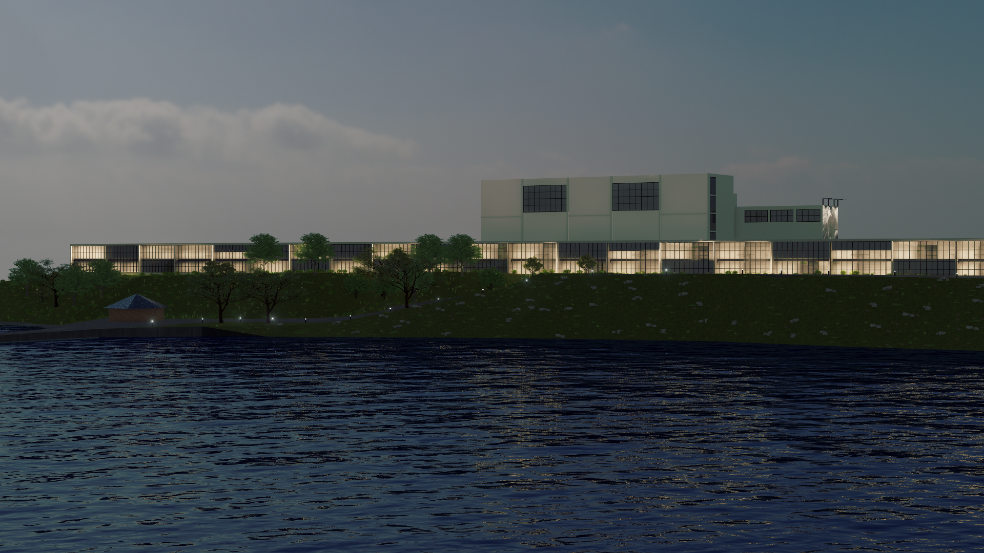Nighttime view of the redeveloped Geelong Power Station overlooking Corio Bay, featuring modern industrial architecture, illuminated glass facades, and landscaped waterfront surroundings. Hamilton Group