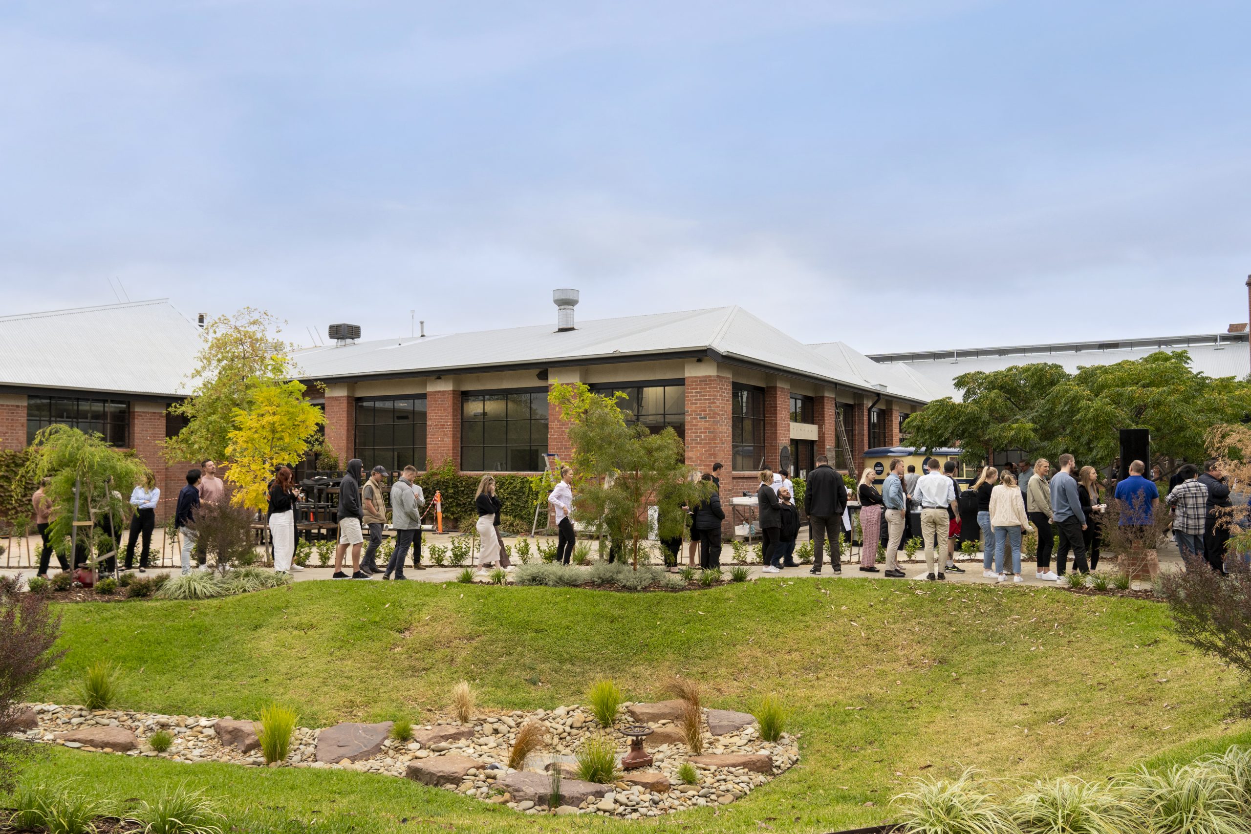 Long line of people waiting to get food from Geelong's most famous bakery, The Paddock