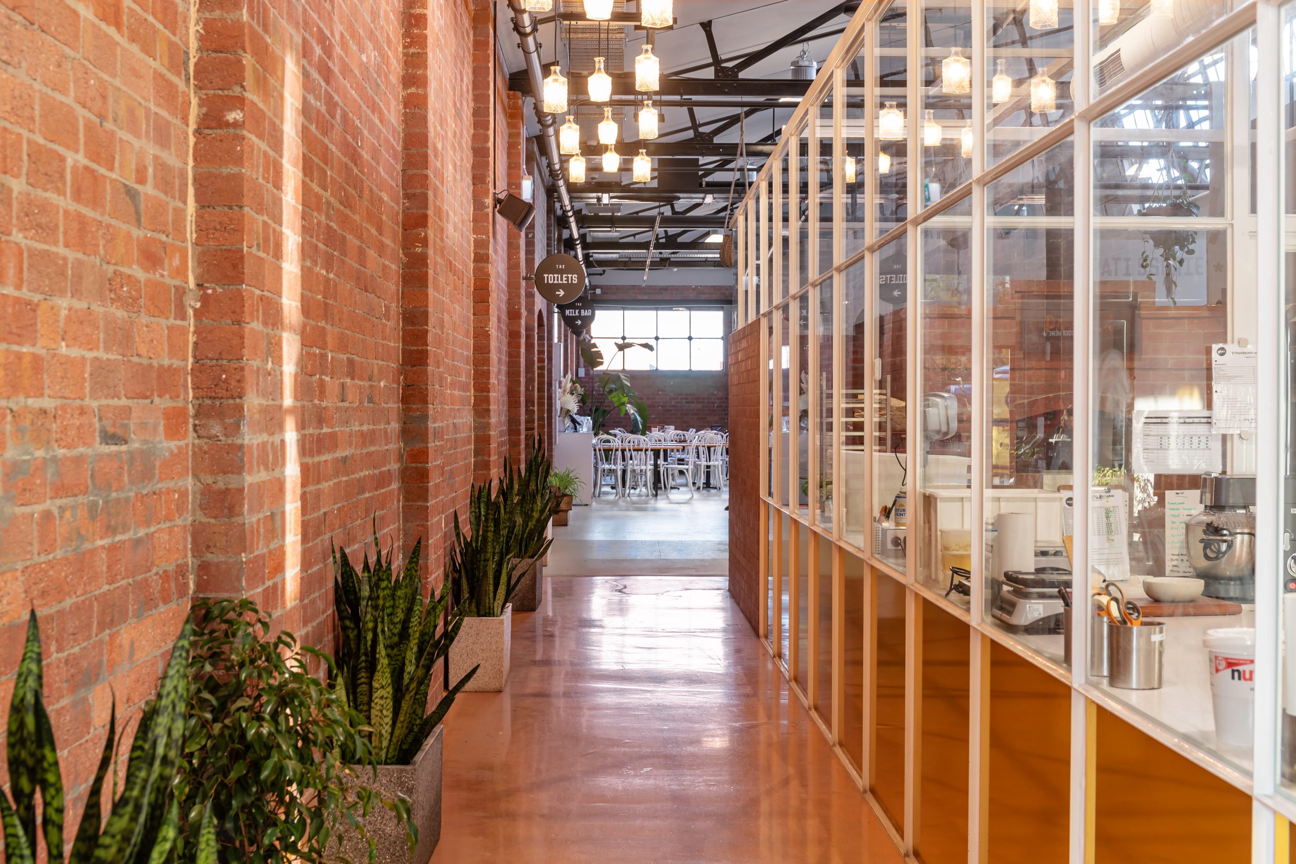 Long hall way passing the famous prep area windows at Geelong's Paddock Bakery