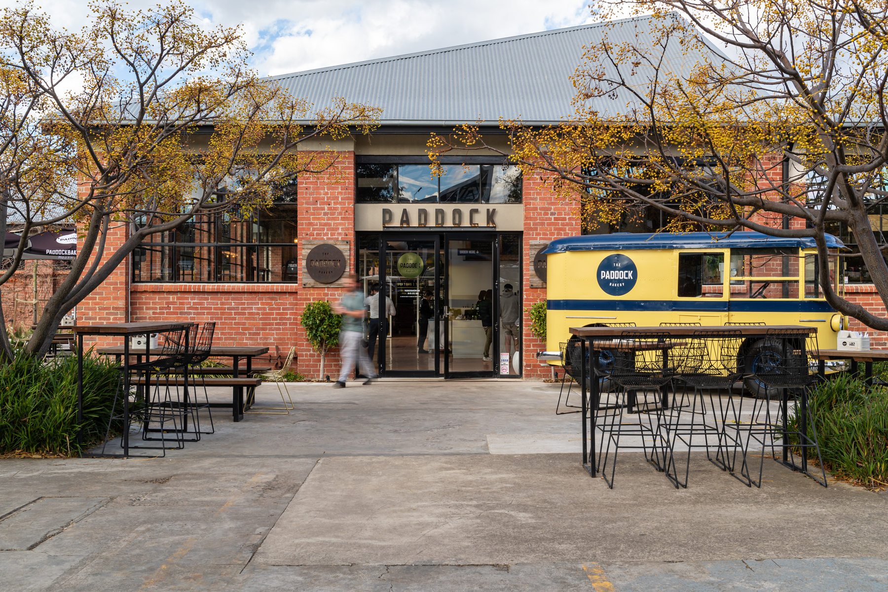 Front entrance with old milk cart parked out the front with Paddock bakery stickers fitted at Federal Mills Geelong