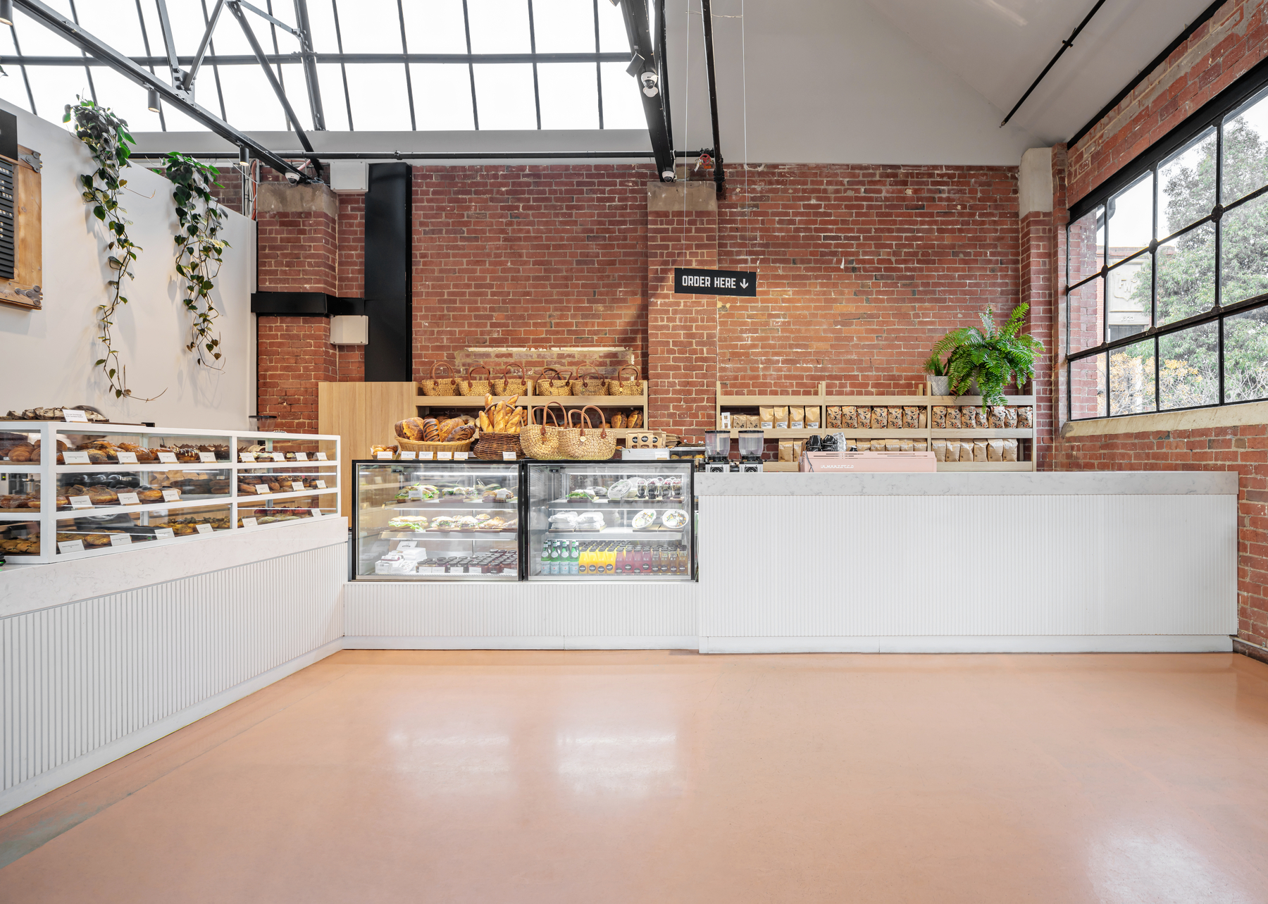 Front food service area with red brick wall at the famous Paddock Bakery North Geelong